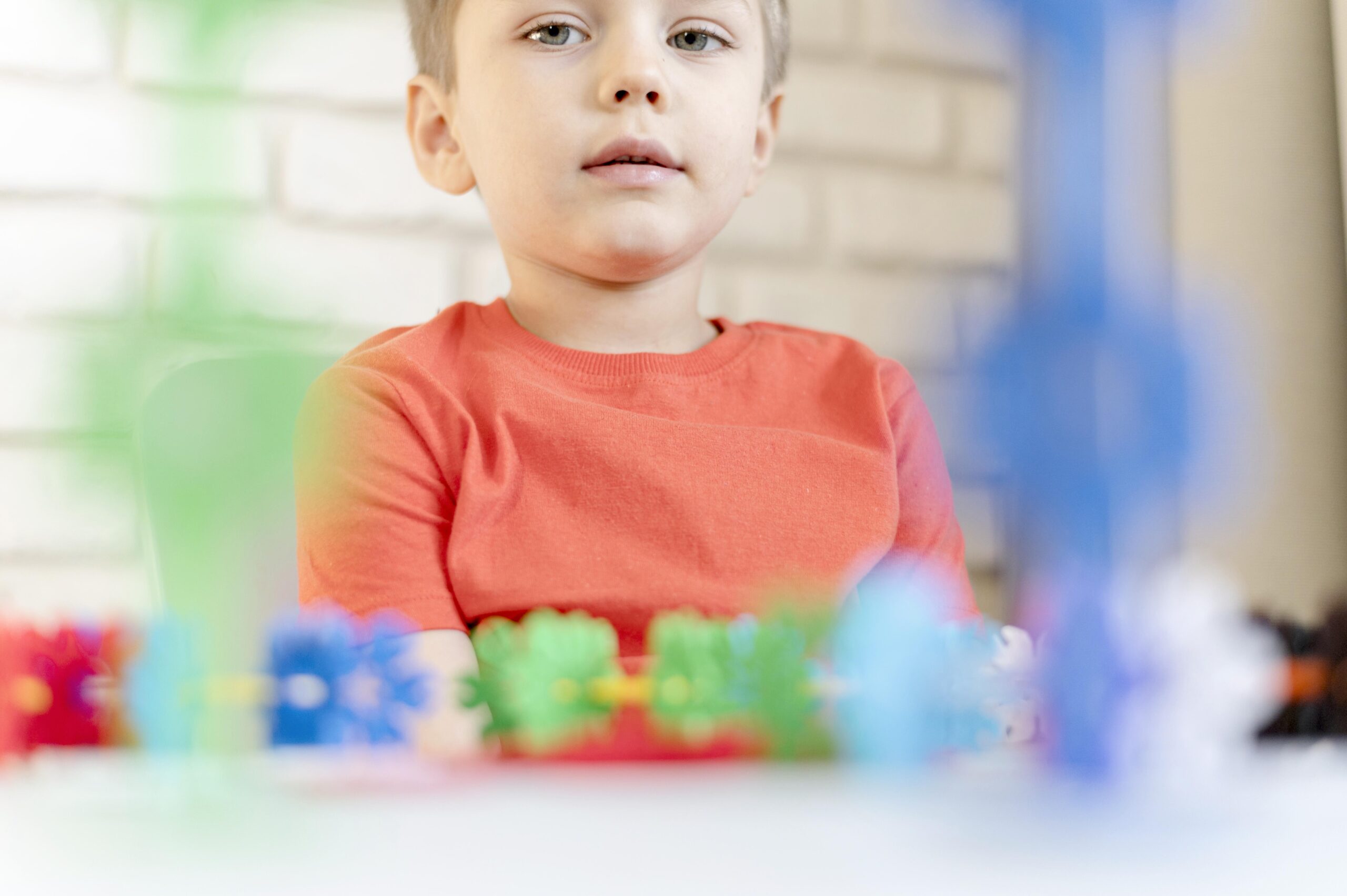 A close-up of a kid with a floral toy