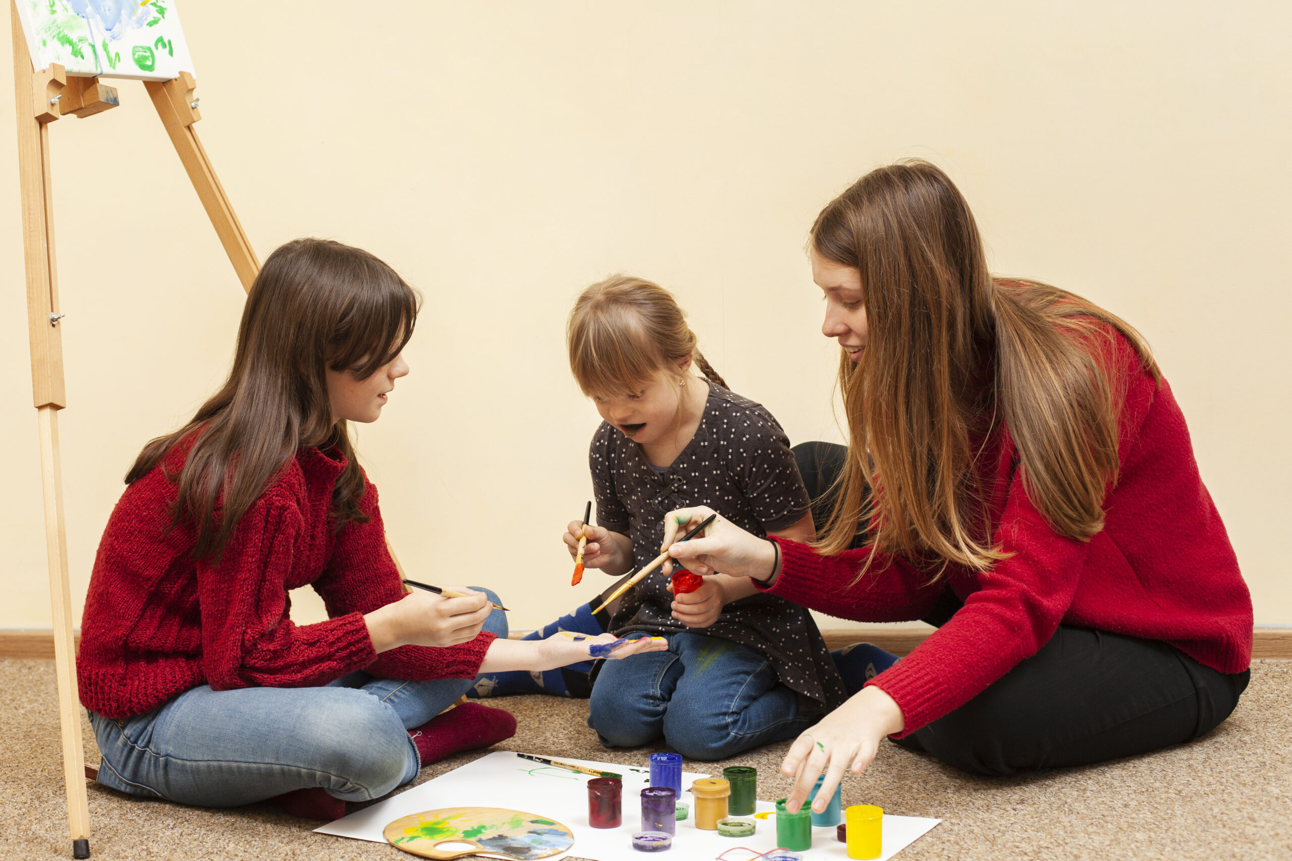 A girl with Down syndrome joyfully painting