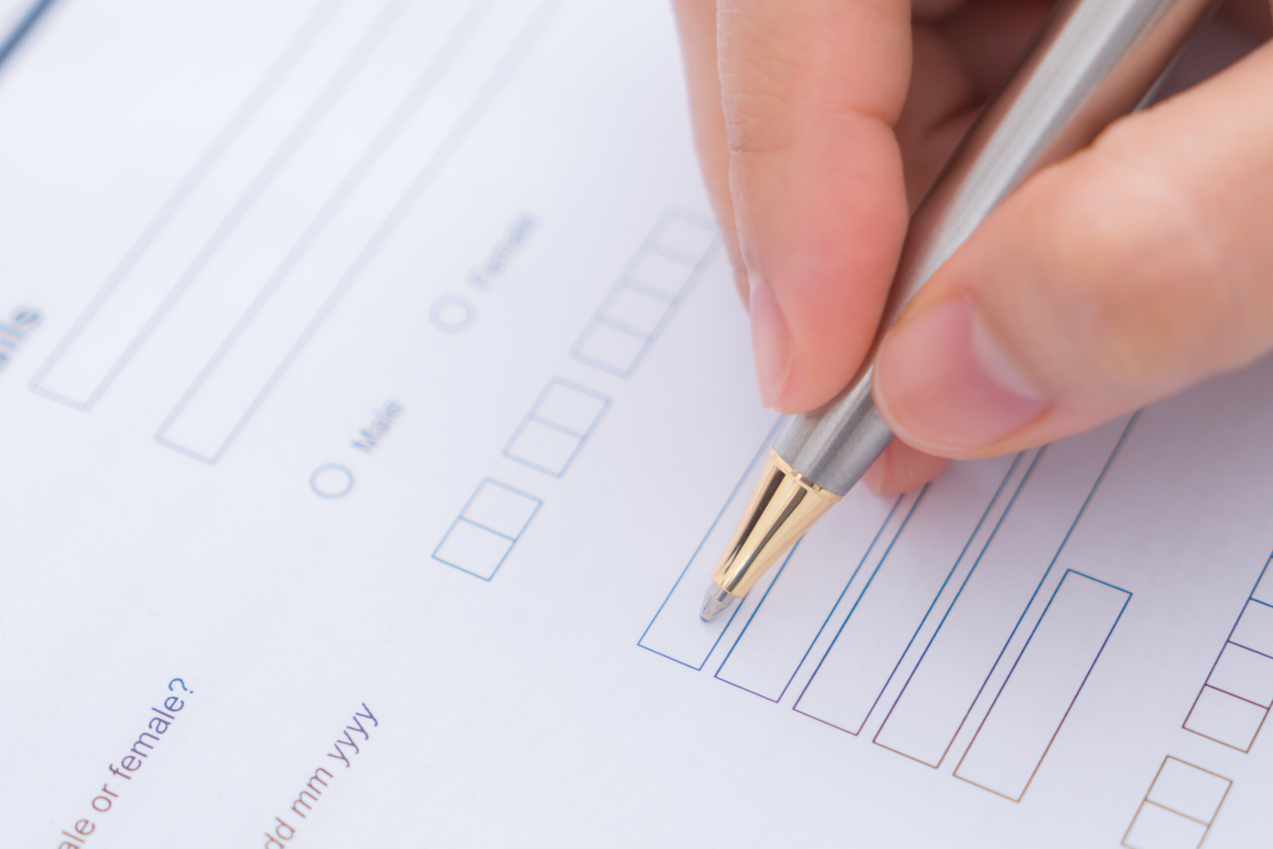 A person filling out an insurance application form