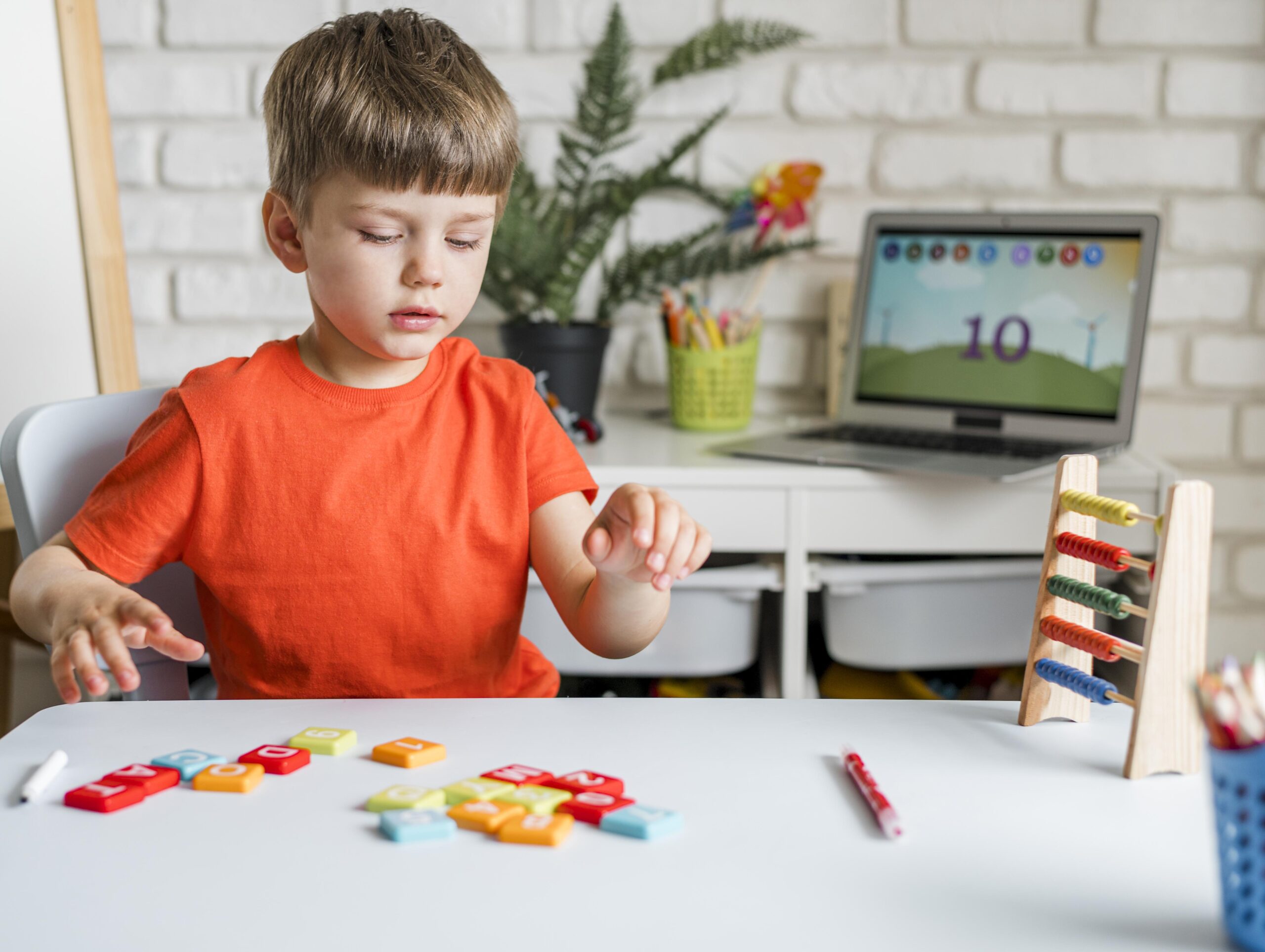 Child learning with letter blocks in a home environment.