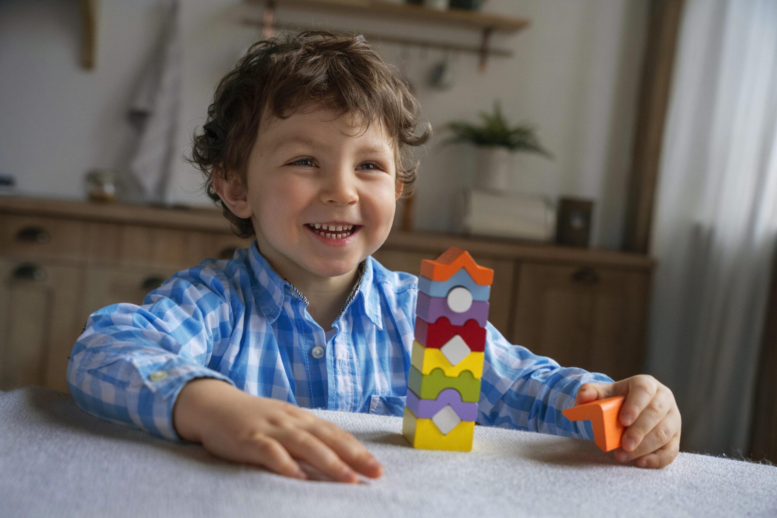 A child engaged in one-on-one play-based therapy at home.