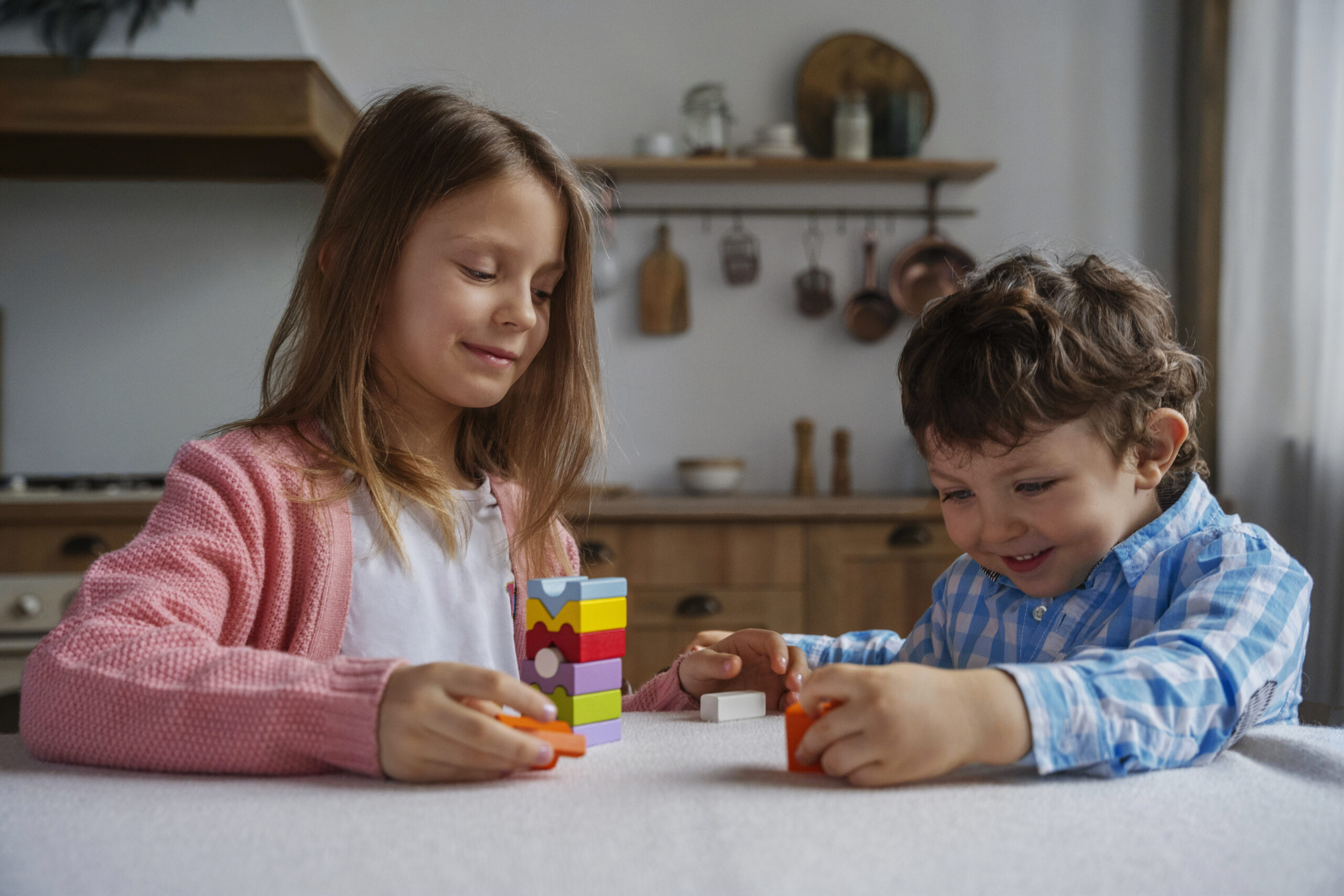 Two children playing a memory game, representing thematic play.