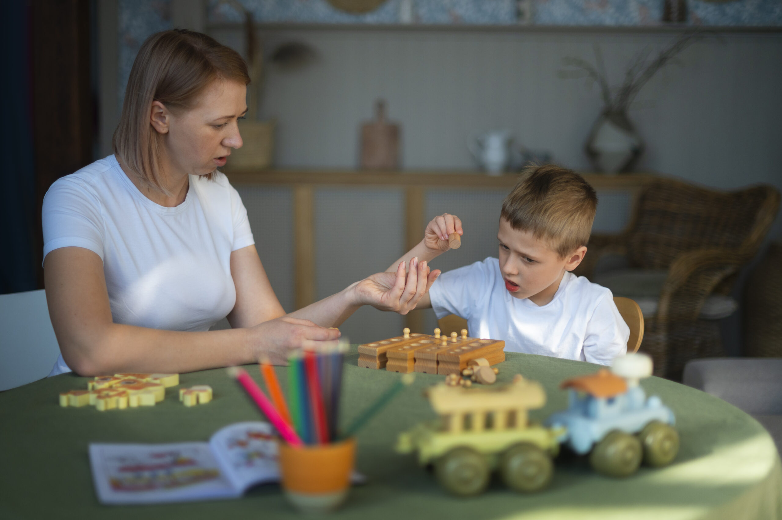 A mother playing with her son and educational toys