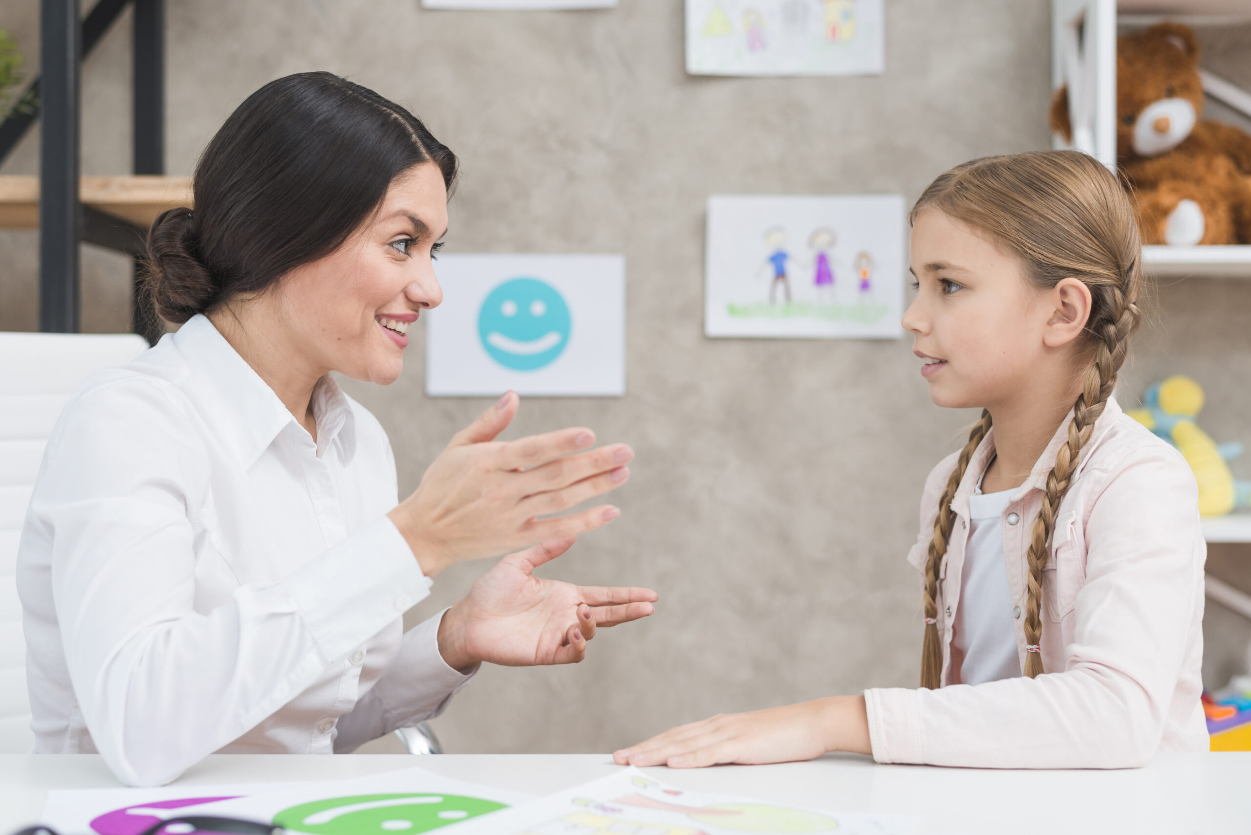 Female psychologist having a conversation with a young girl