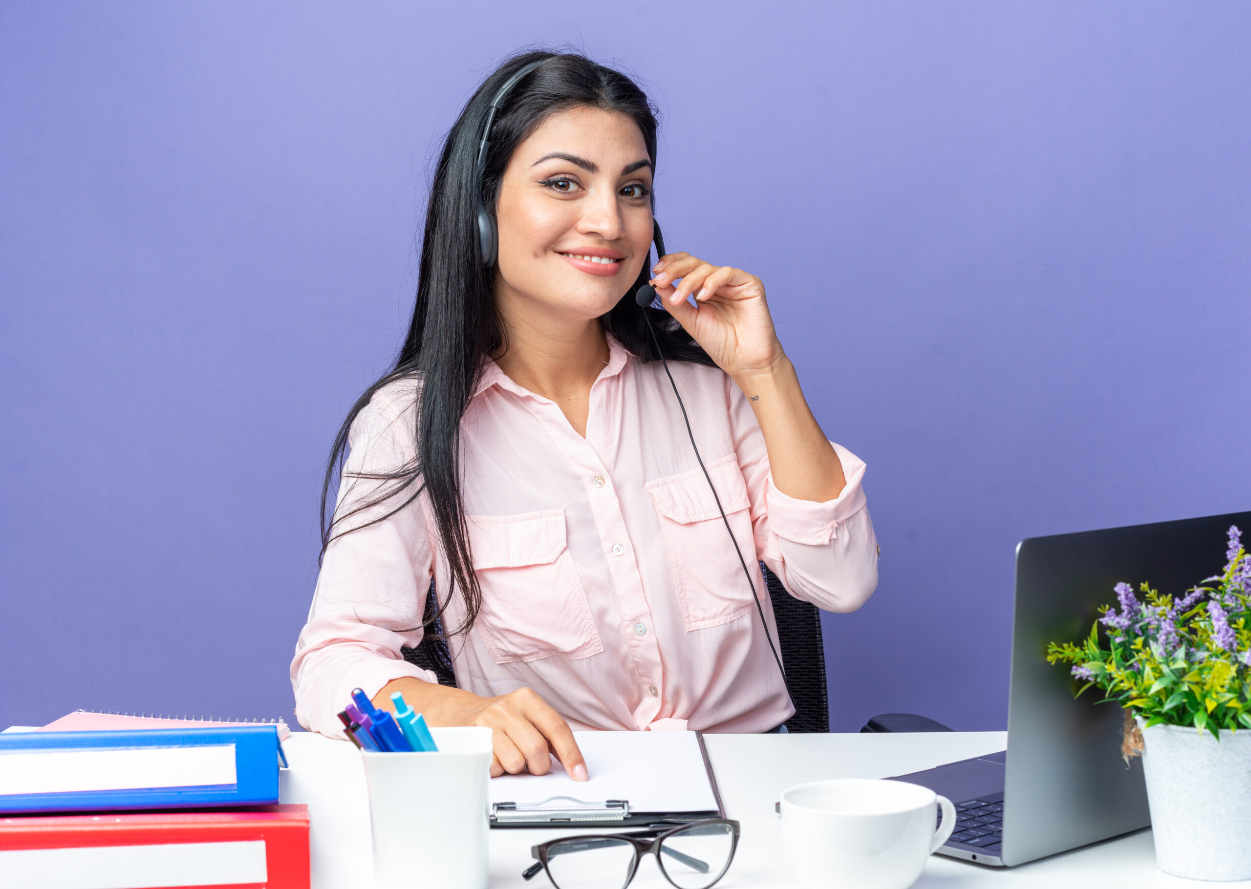 A friendly intake coordinator with a headset during a consultation call