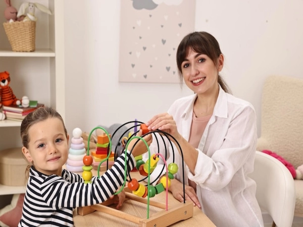 Child happily painting during a therapy session
